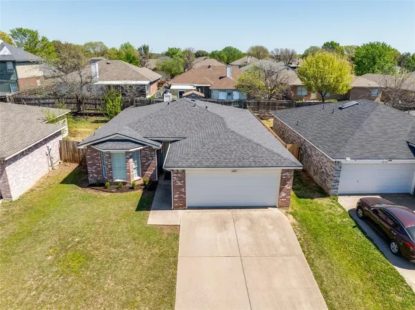 a aerial view of a house with a yard and sitting area