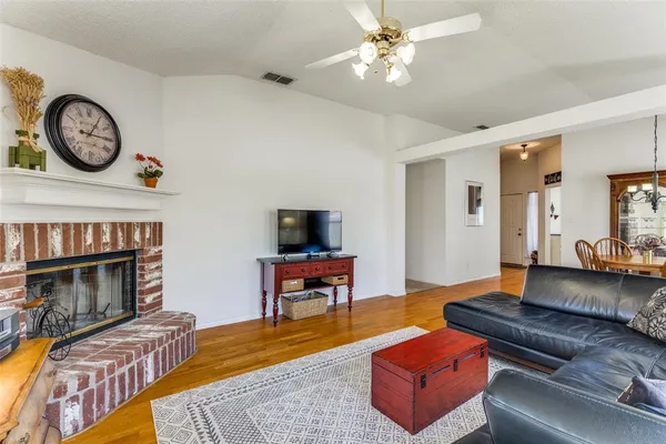 a living room with furniture a clock and a fireplace