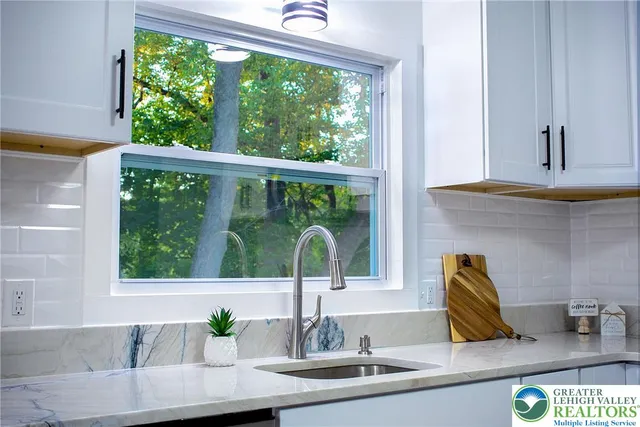 a kitchen with a sink and a large window