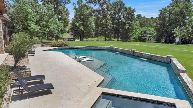 a view of a backyard with swimming pool