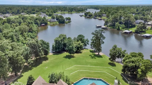 an aerial view of a houses with a lake view