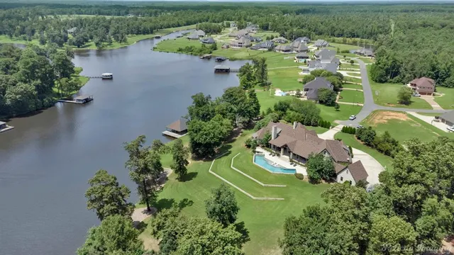 an aerial view of a house with a lake view