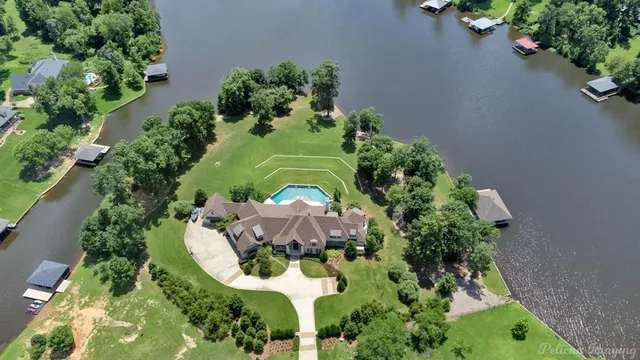 an aerial view of a house with a yard and garden