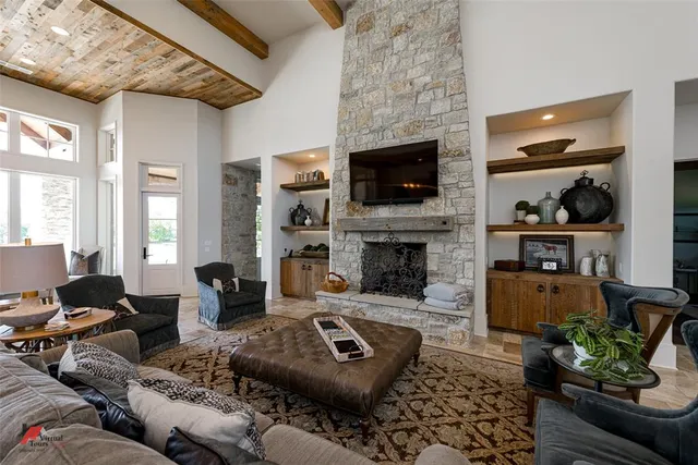 a living room with furniture a flat screen tv and a fireplace