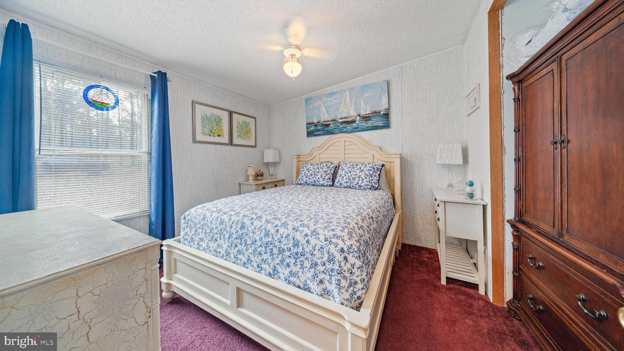 32520 Seatick Road Eden, MD 21822 - Photo 15 of 31 a bedroom with a bed and a chandelier