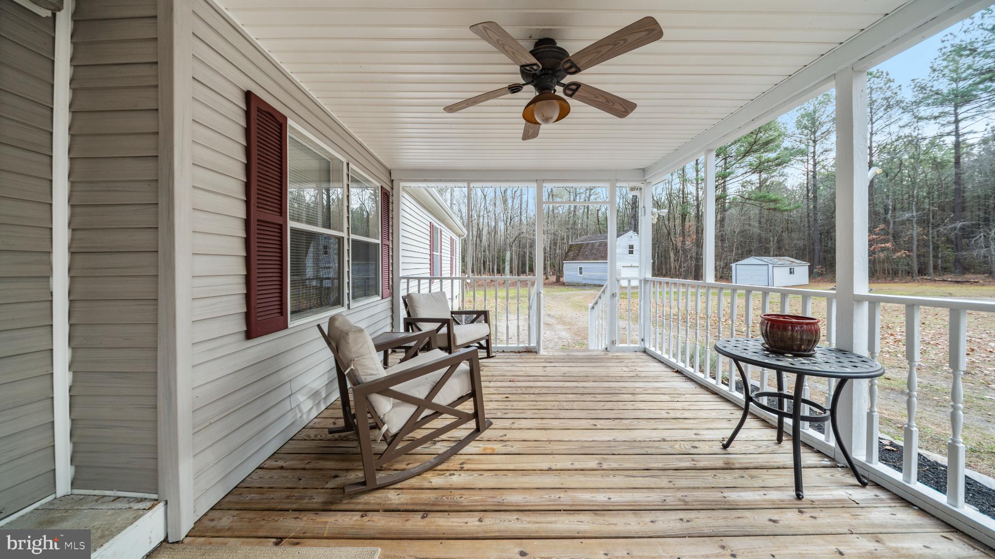 32520 Seatick Road Eden, MD 21822 - Photo 3 of 31 a view of a patio with a table chairs and wooden floor