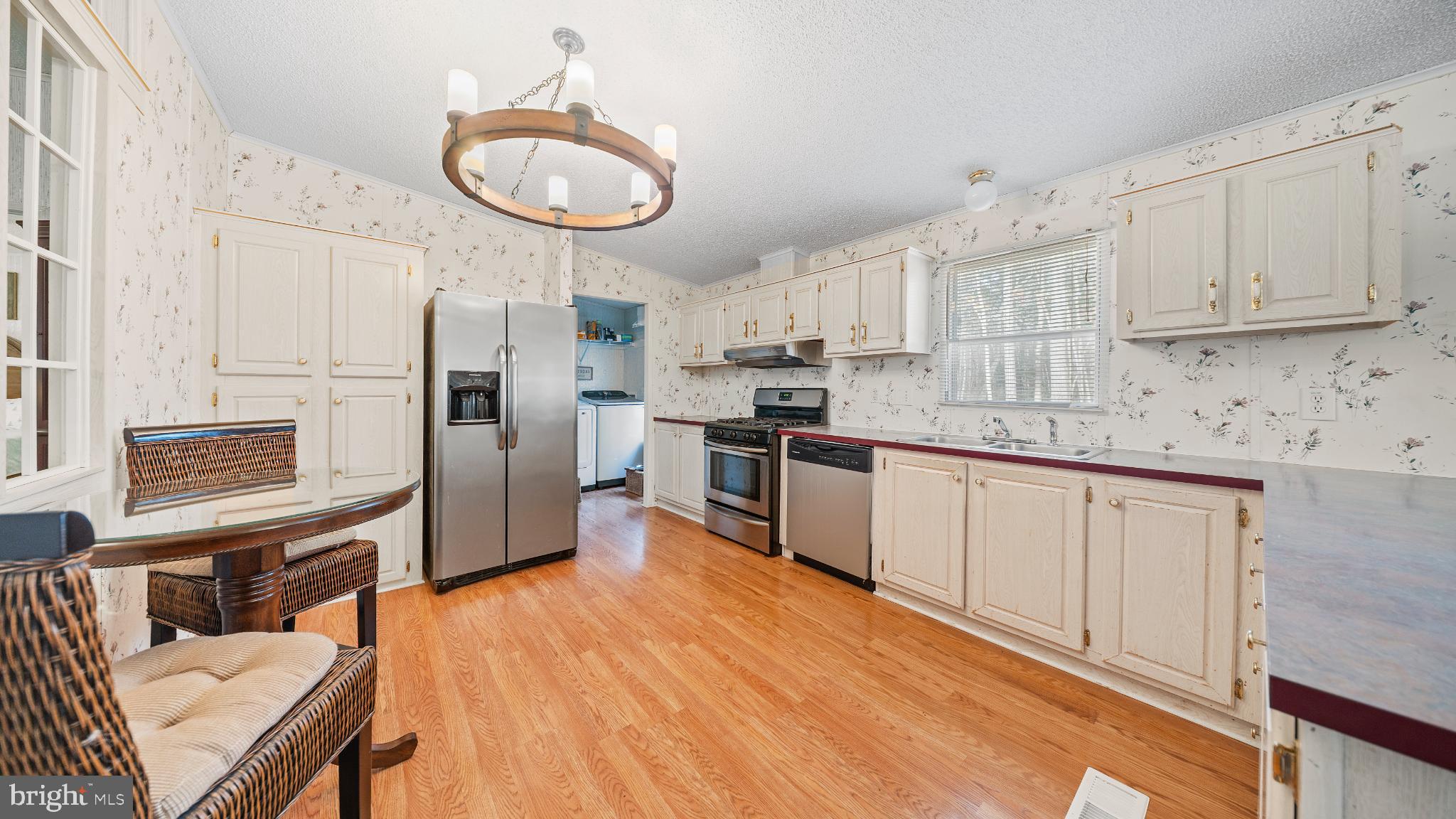 32520 Seatick Road Eden, MD 21822 - Photo 10 of 31 a kitchen with stainless steel appliances granite countertop a refrigerator a sink dishwasher a stove with wooden cabinets and floor