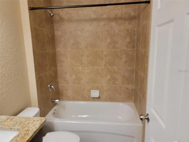 a bathroom with a bathtub and shower