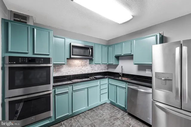 a kitchen with a refrigerator sink and microwave