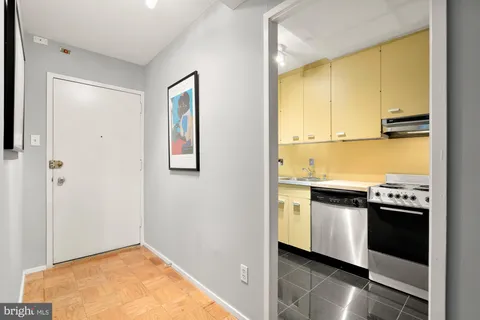 a kitchen with appliances a sink and cabinets
