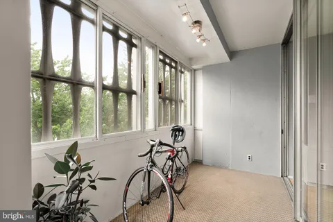 a bedroom with a bed and a large window