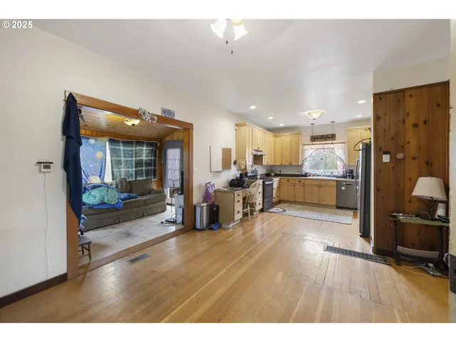 a open kitchen with sink and refrigerator