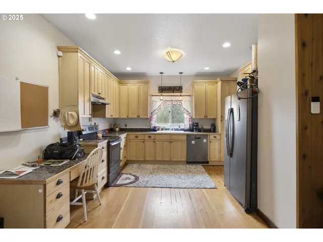 a kitchen with a sink stainless steel appliances and cabinets