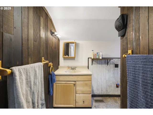 a bathroom with a sink vanity and mirror