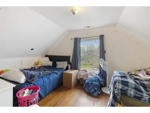 a bedroom with furniture and a window