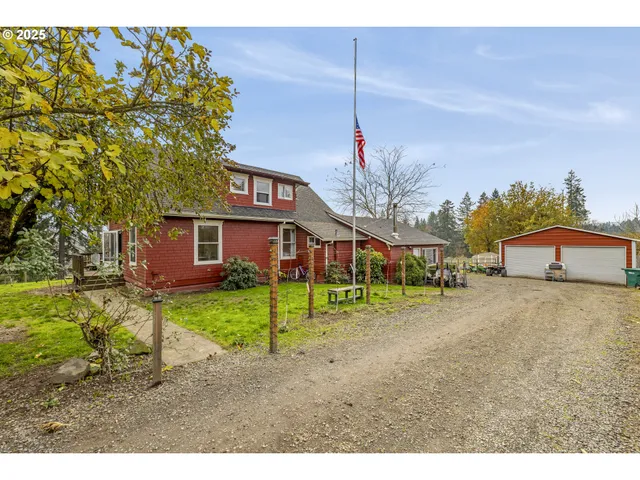 a yellow and red house with a big yard