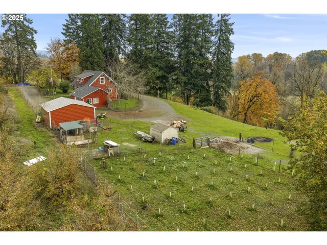 a aerial view of a house with a yard basket ball court and outdoor seating