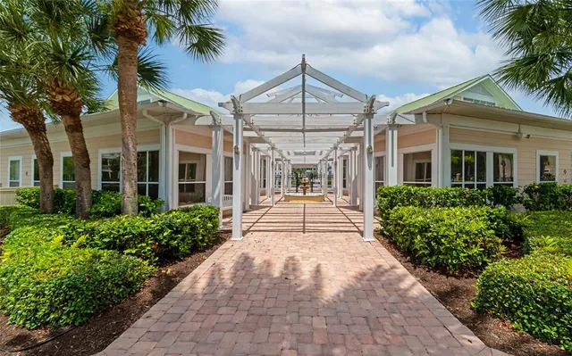 front view of a house with a small yard and potted plants