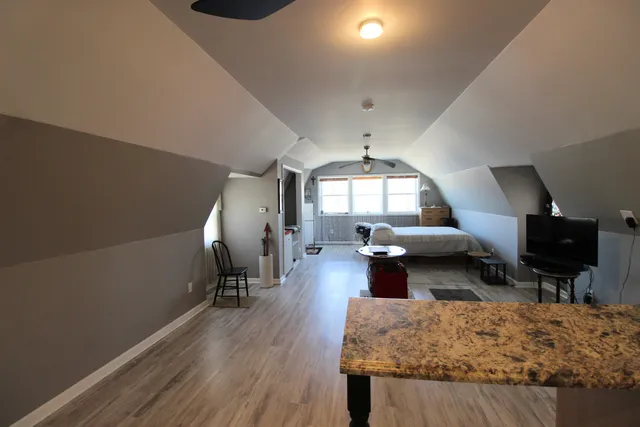 a living room with fireplace furniture and a wooden floor