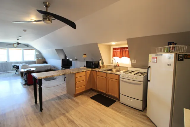 a kitchen with a sink appliances and cabinets