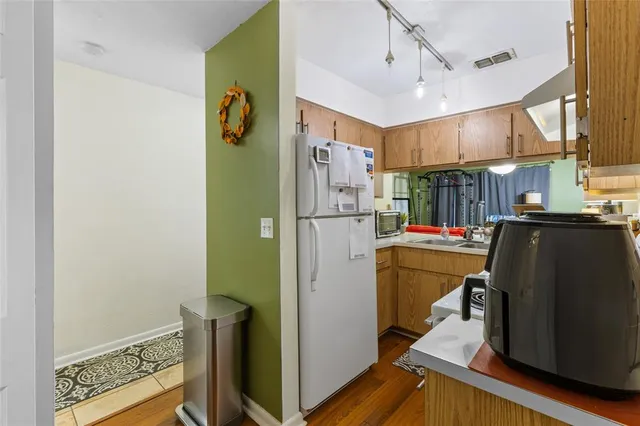 a kitchen with refrigerator and window
