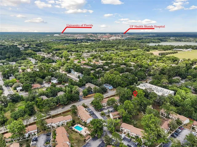 an aerial view of a houses with a yard