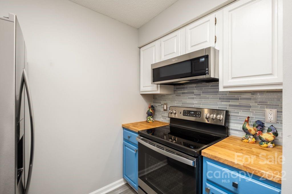 5003 Sharon Road, Unit C Charlotte, NC 28210 - Photo 11 of 27 a kitchen with a stove and a microwave