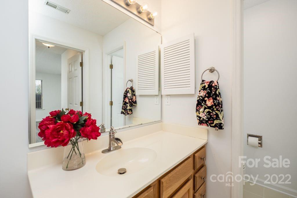 5003 Sharon Road, Unit C Charlotte, NC 28210 - Photo 16 of 27 a bath room with a sink and mirror