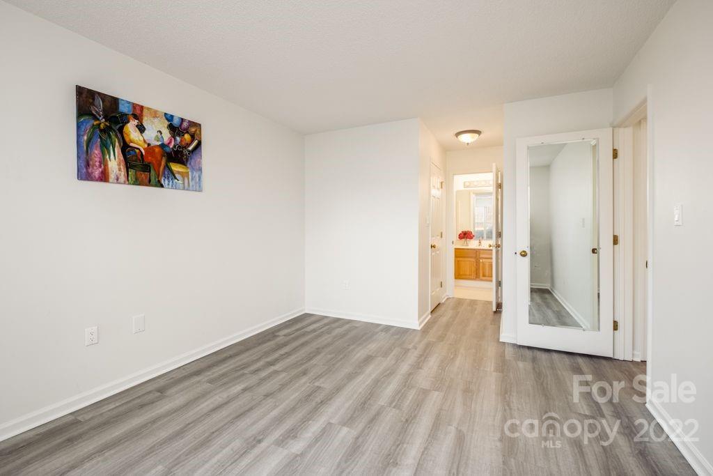 5003 Sharon Road, Unit C Charlotte, NC 28210 - Photo 17 of 27 wooden floor in an empty room with a window