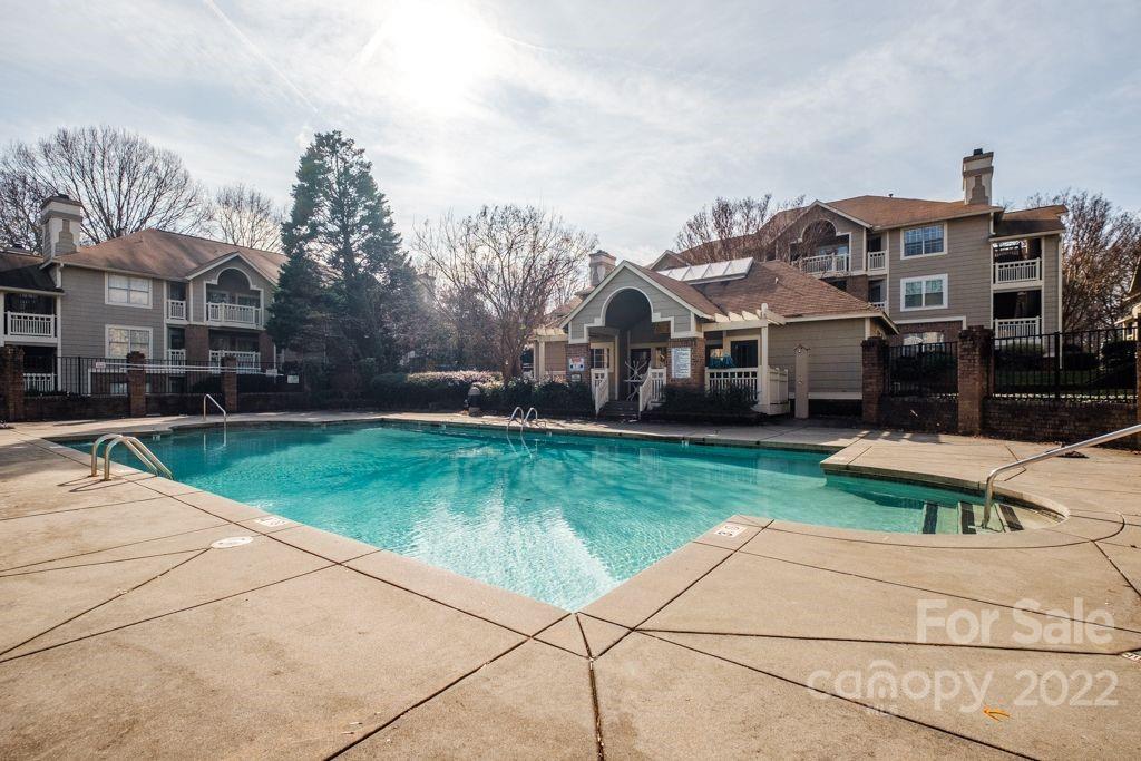 5003 Sharon Road, Unit C Charlotte, NC 28210 - Photo 25 of 27 a front view of a house with garden