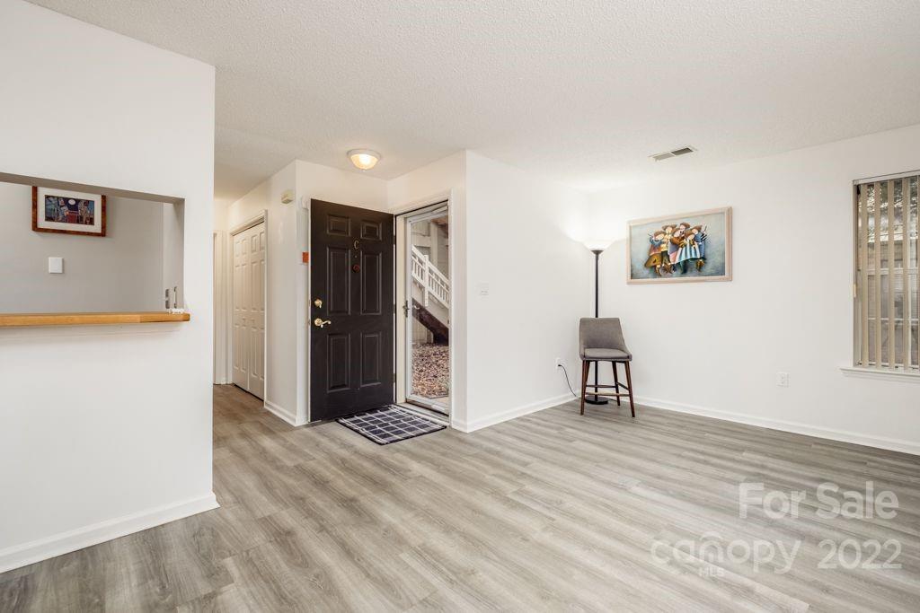 5003 Sharon Road, Unit C Charlotte, NC 28210 - Photo 3 of 27 a view of a livingroom with wooden floor and a cabinet