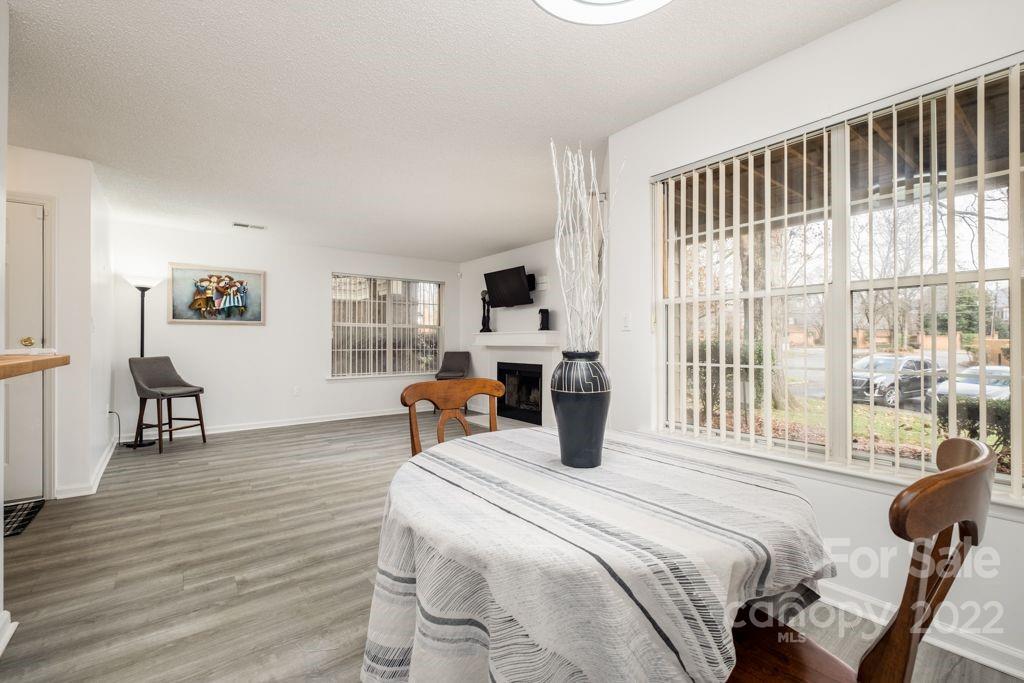 5003 Sharon Road, Unit C Charlotte, NC 28210 - Photo 6 of 27 a bedroom with a bed and wooden floor