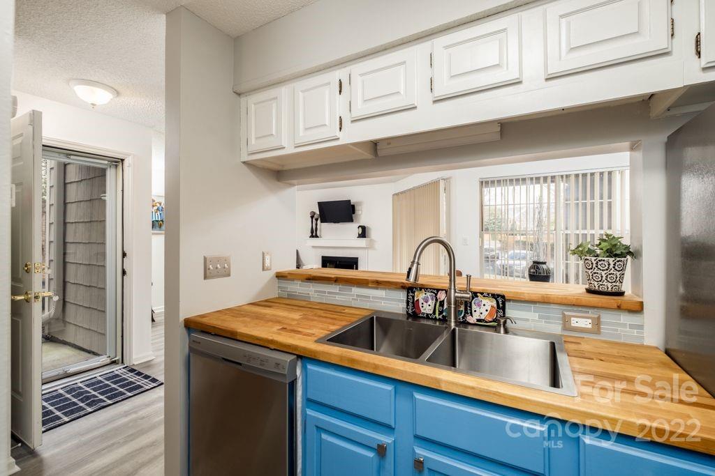 5003 Sharon Road, Unit C Charlotte, NC 28210 - Photo 9 of 27 a kitchen with stainless steel appliances granite countertop a sink and cabinets