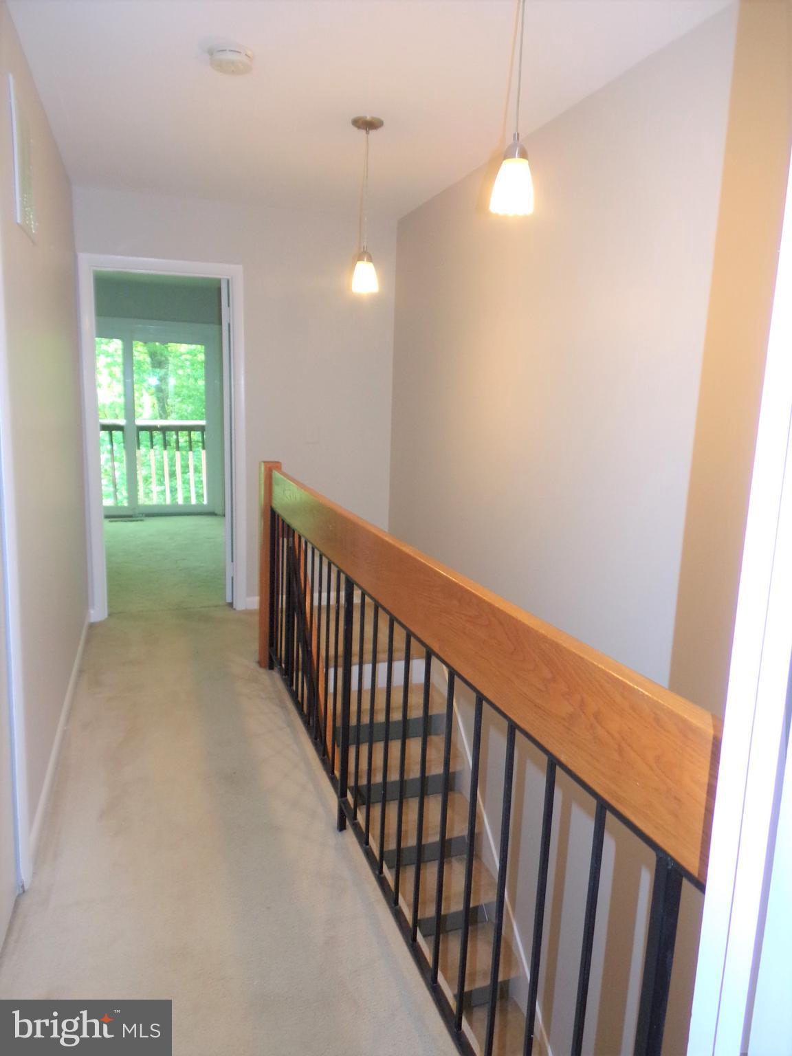1952 Winterport Cluster Reston, VA 20191 - Photo 25 of 51 Hallway to front bedroom and laundry on the right