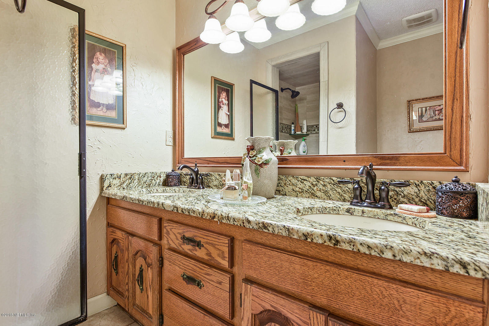 54219 Marlee Road Callahan, FL 32011 - Photo 12 of 26 a bathroom with a granite countertop sink and a mirror