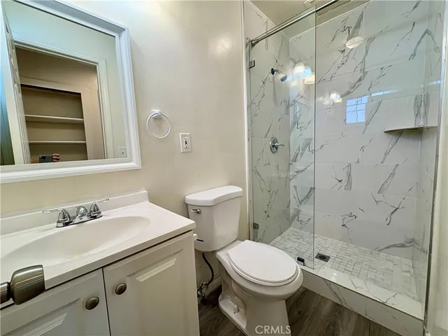 a bathroom with a sink and a glass door shower