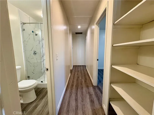 a view of a room with wooden floor and window
