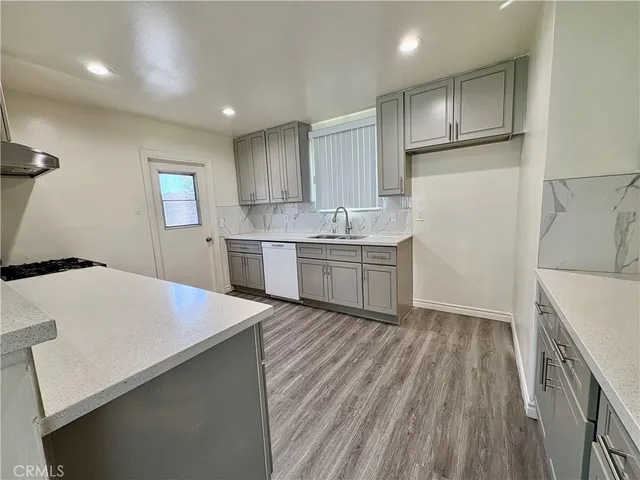 a kitchen with cabinets a sink and appliances