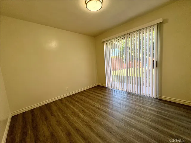 a view of a room with wooden floor and a carpet