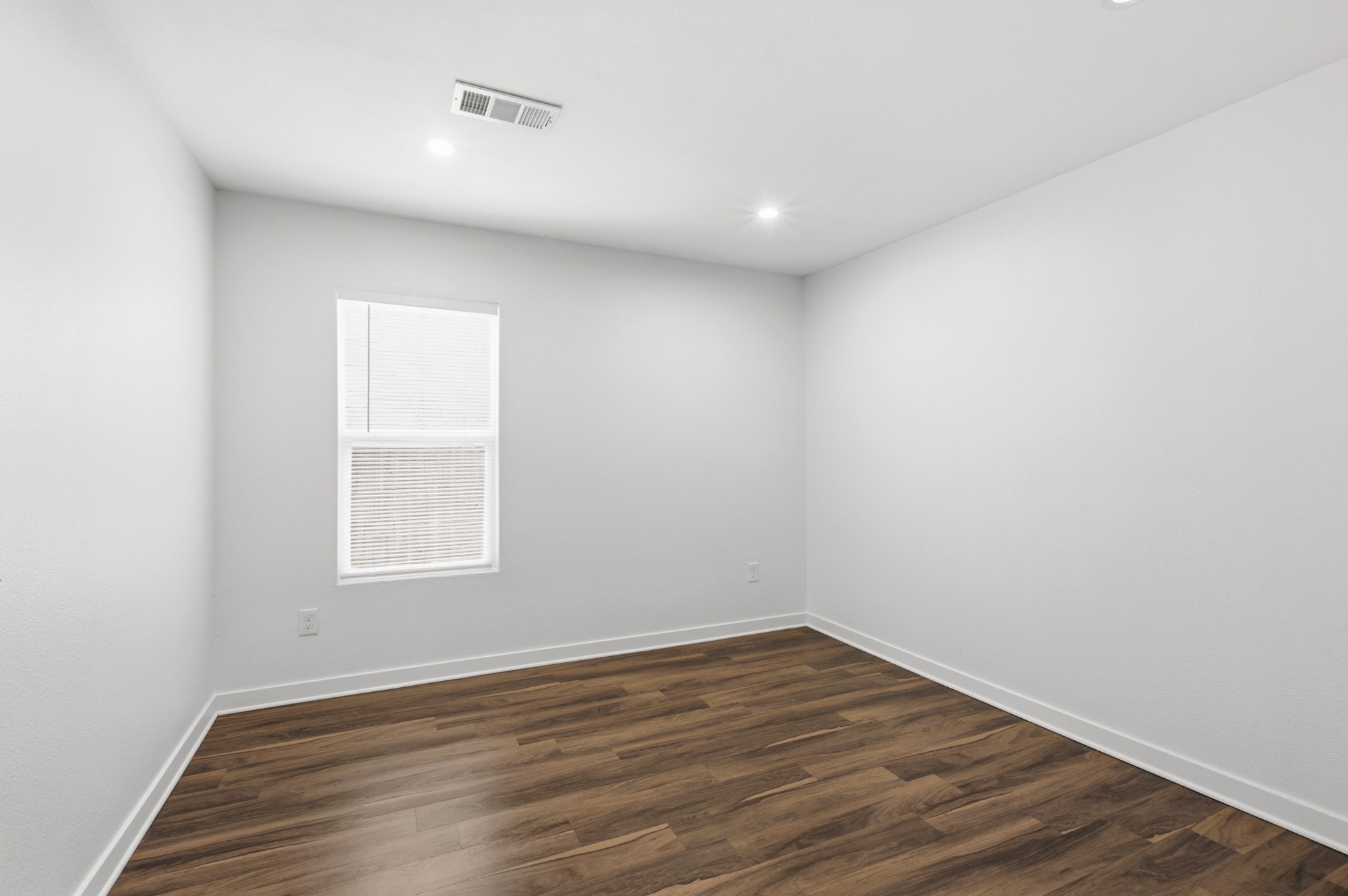 108 Irene Street Elgin, TX 78621 - Photo 17 of 29 Unfurnished room featuring dark wood-style floors and recessed lighting