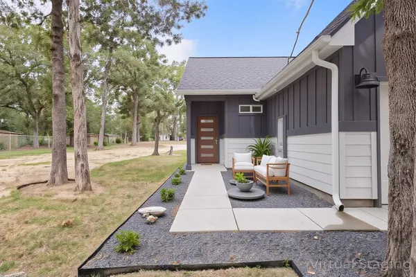 a view of a house with backyard and sitting area