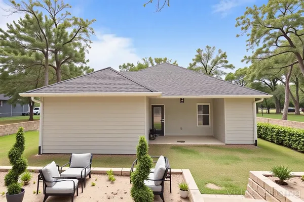 an aerial view of a house with a yard