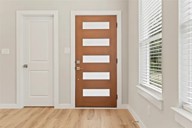 a bathroom with a granite countertop sink a toilet and shower