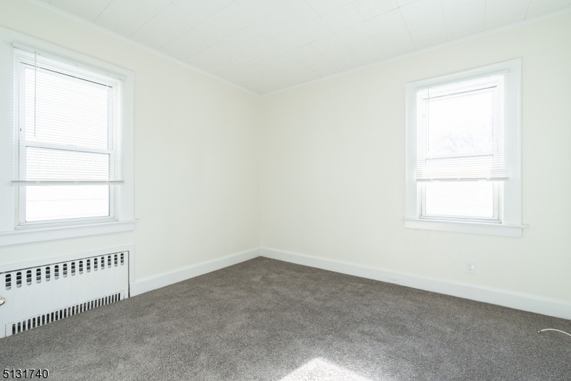 208 Tuscan Road, Unit 1 Maplewood, NJ 07040 - Photo 11 of 15 an empty room with a window