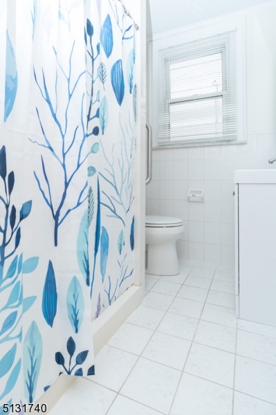 208 Tuscan Road, Unit 1 Maplewood, NJ 07040 - Photo 15 of 15 a bathroom with a toilet and a shower curtain