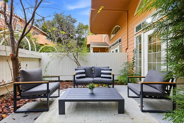 a view of a patio with table and chairs and potted plants