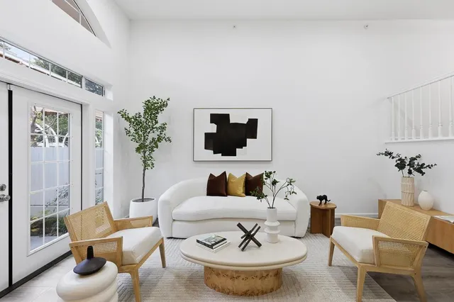 a living room with furniture and a potted plant