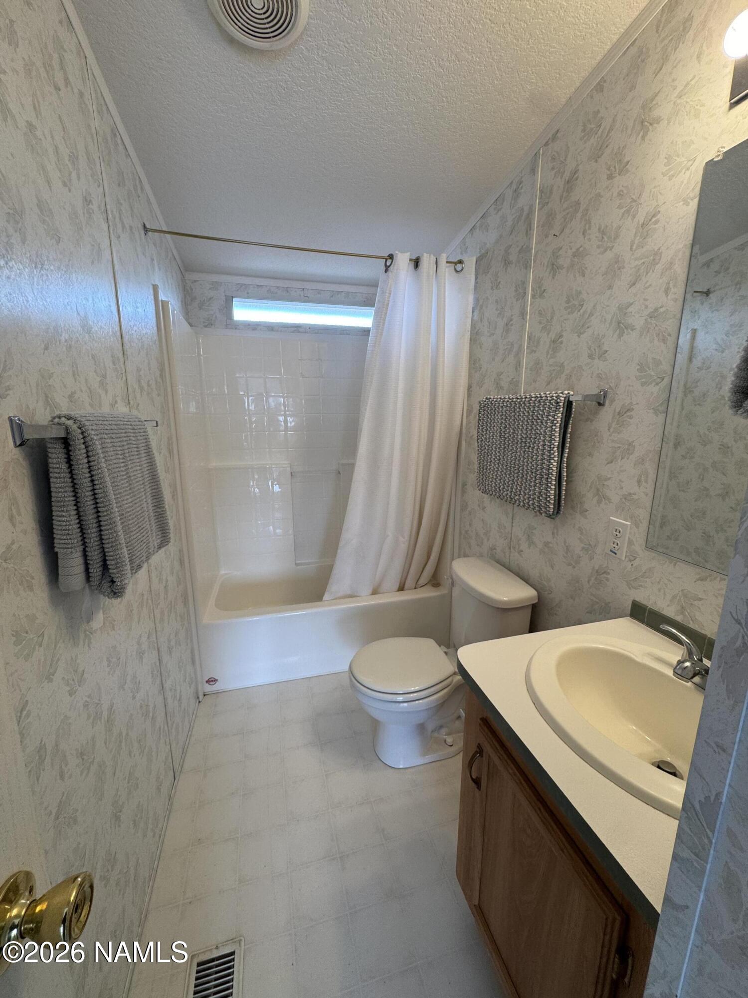 768 Mountain Cat Road Williams, AZ 86046 - Photo 17 of 37 a bathroom with a sink a toilet and shower