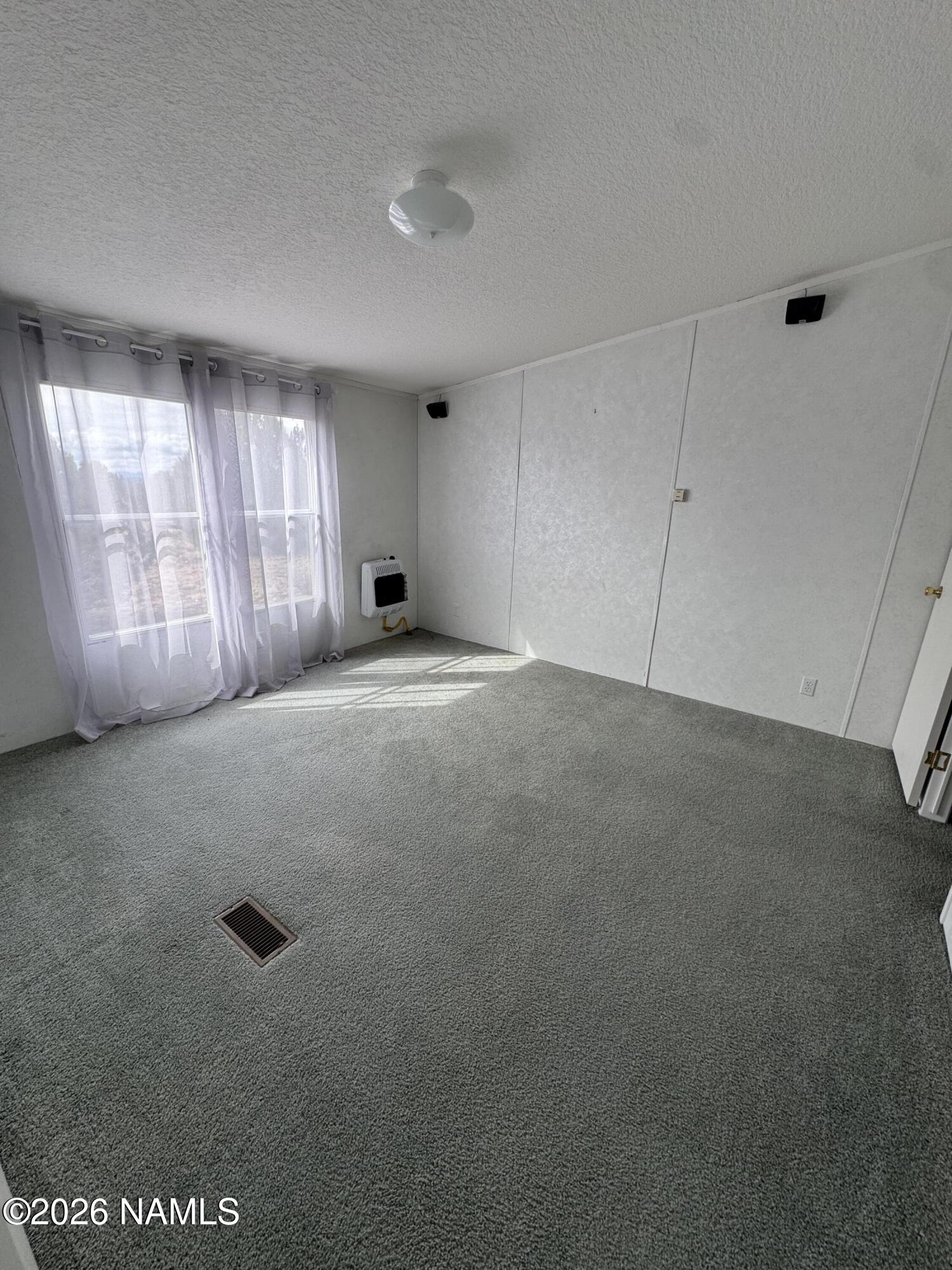 768 Mountain Cat Road Williams, AZ 86046 - Photo 18 of 37 a view of an empty room with a window