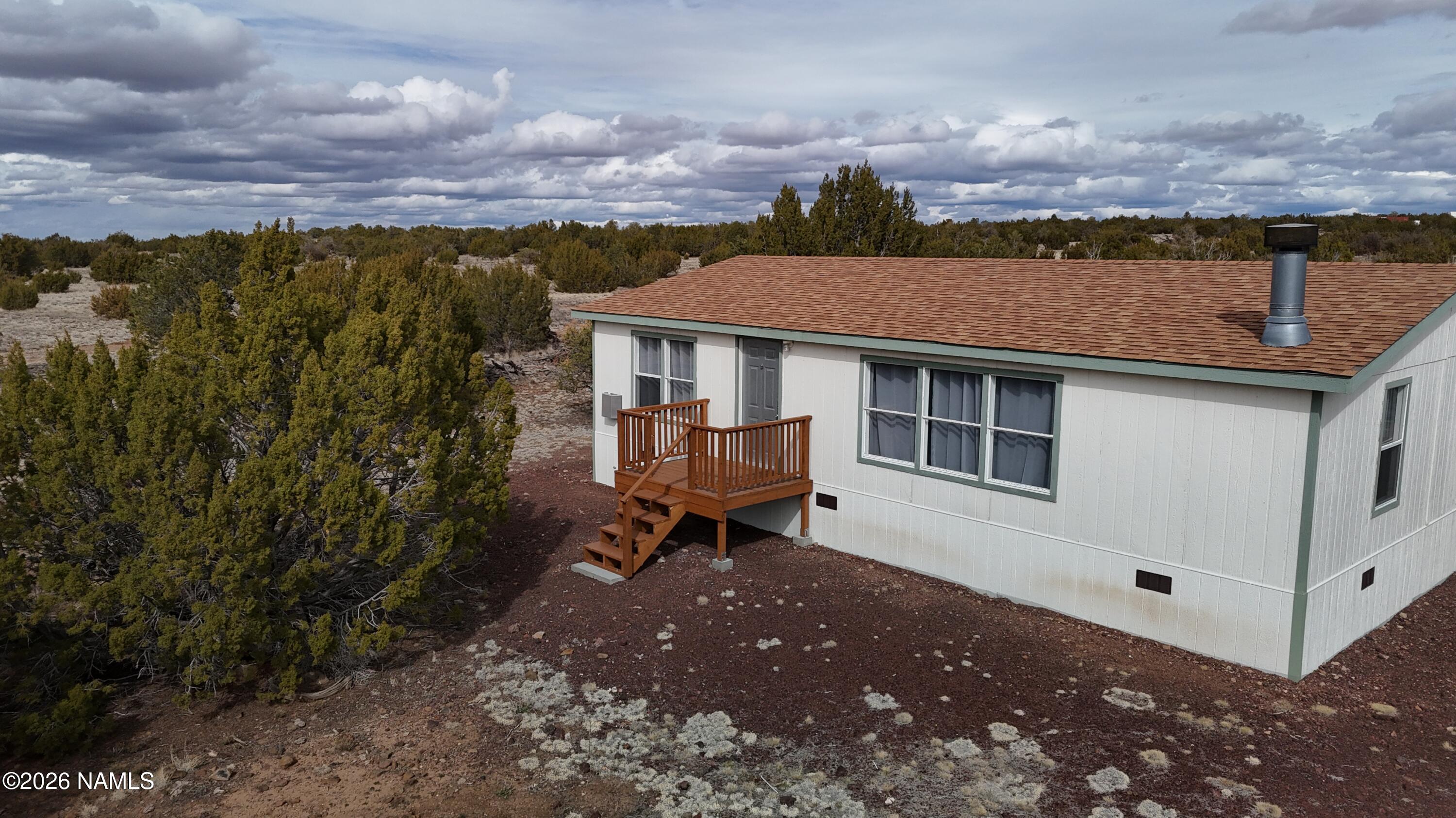 768 Mountain Cat Road Williams, AZ 86046 - Photo 2 of 37 a backyard of a house with a yard and mountain